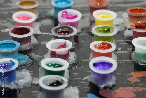 Colored inks in caps or containers ready for tattooing or painting