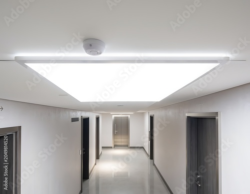 Modern Office Corridor with Illuminated Ceiling Panels.