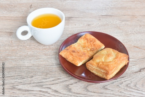 assorted sweet dessert pie and salty tuna pie with orange juice cup on table