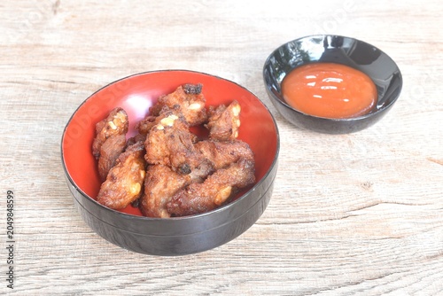 fried fermenting pork cartilage bone with garlic on bowl dipping spicy chili sauce