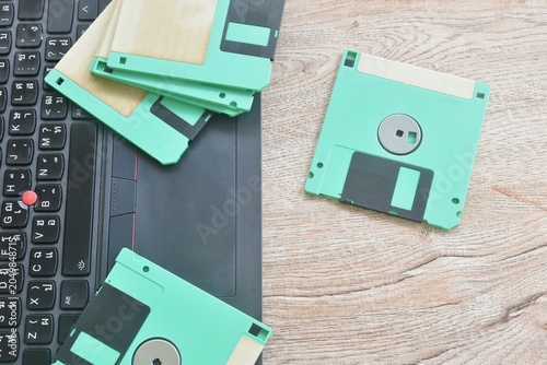 floppy disk old technology for saving data arranging with laptop computer on table