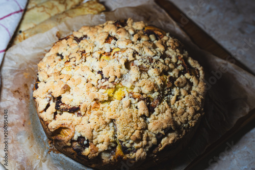 Fényképezés Delicious homemade cake with crumbly topping placed on parchment paper, ideal fo