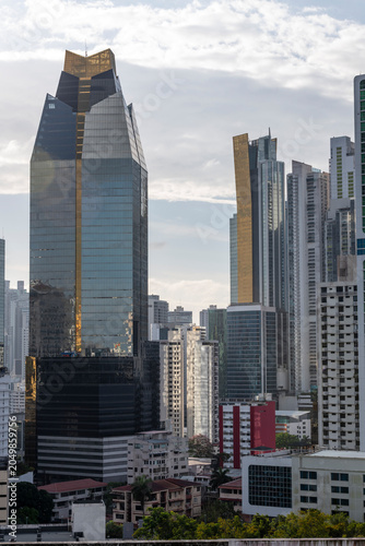 Panama city skyline showcasing contemporary skyscrapers and residential buildings, reflecting the vibrant commercial and urban development of the city under a cloudy sky - stock photo