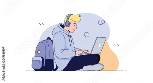 Young man wearing a hoodie and headphones sitting on the floor with a backpack and working or studying on his silver laptop.
