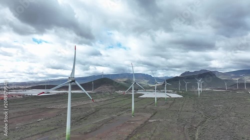 A drone flight over a wind farm at sunset