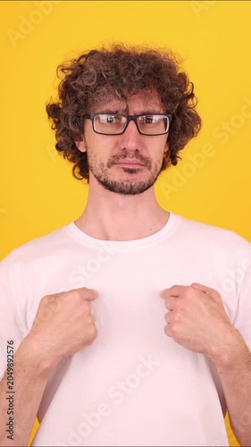 Person pointing at themselves with a shocked amazed expression, reacting with a vivid who, me? gesture against a bright yellow background.
