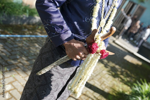 Javanese Groom Holding Traditional Keris Dagger Wedding Attire