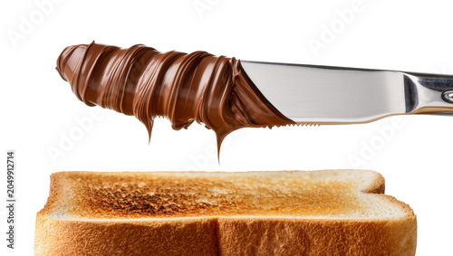 Cuadro en lienzo Knife spreading chocolate hazelnut spread on toasted bread slice, isolated on tr
