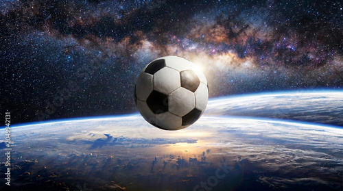 Soccer Ball Floating in Outer Space Above Planet Earth, Milky Way Galaxy
