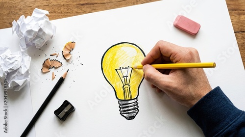 Creative Process of Drawing a Light Bulb Idea on Paper.