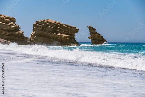 Schilderij op canvas Landscape with waves crashing against characteristic rocks on Triopetra Beach on