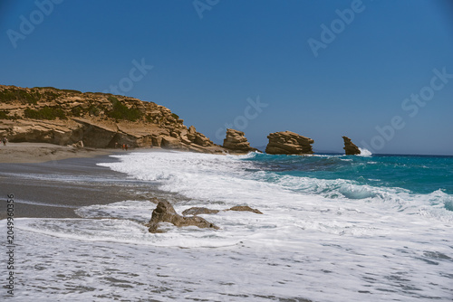 Schilderij op canvas Landscape with waves crashing against characteristic rocks on Triopetra Beach on