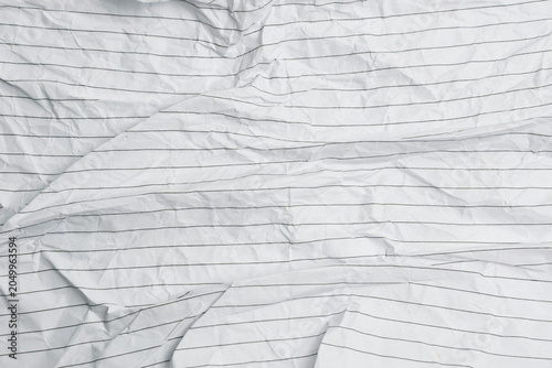 Crumpled white lined paper texture with natural folds and wrinkles. Ideal for graphic design, presentations, stationery mockups, creative projects, and textured backdrop concepts.