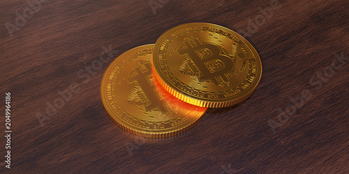 Golden bitcoin coins on a wooden table in focus