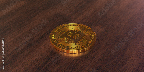 Golden bitcoin coin on a wooden table in focus