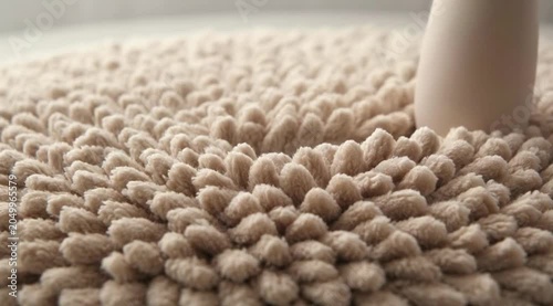 Close up hand holding sponge brush and needle for textile knitting craft