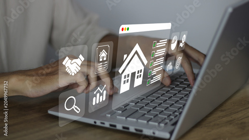 Tableau sur toile Analyzing real estate investment on a laptop, evaluating property options, check