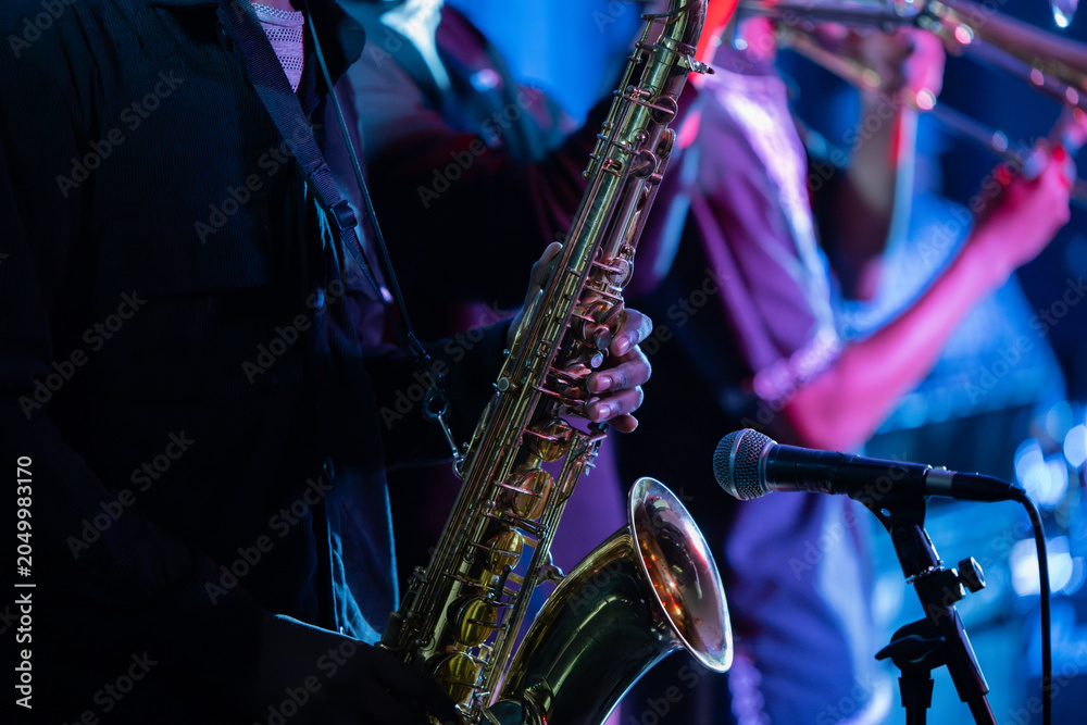 Obraz premium Close up shot of man playing a saxophone 