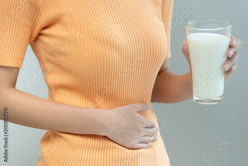 Tableau sur toile Milk allergens, woman felling stomachache and diarrhea , runny stuffy sore nose suffer from intolerance allergy trigger symptoms