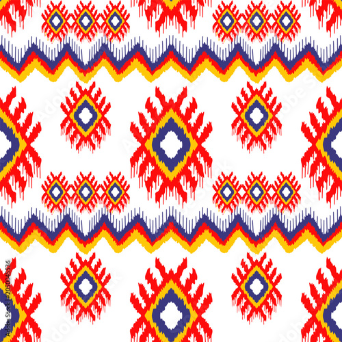 Colorful ikat and chevron seamless pattern, vibrant red and blue geometric ethnic background