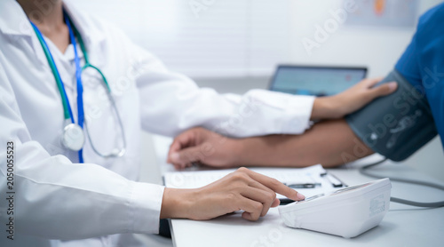 Konstfotografi Blood pressure monitoring and patient examination in healthcare clinic with medi