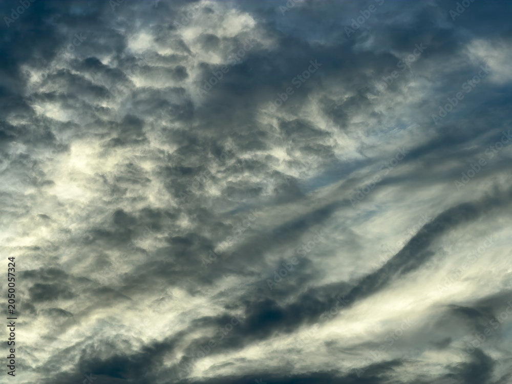 Obraz premium Dynamic evening cloudscape at golden hour on the first official day (June 1) of Atlantic hurricane season in southwest Florida. Motifs of wind flow and changeability.