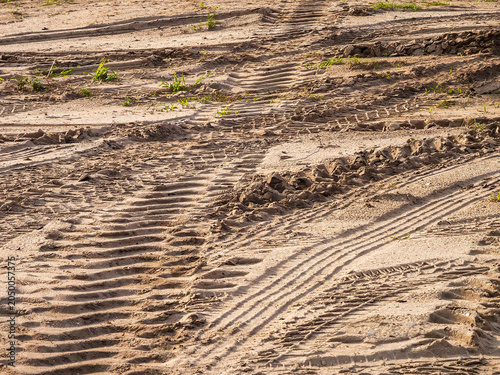 Billede på lærred Track marks of heavy machinery across a sandy lot, future site of house construction, in a suburban development on a sunny morning in southwest Florida