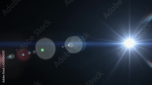 Bright Lens Flare Effect with Starburst and Bokeh Over Dark Background.