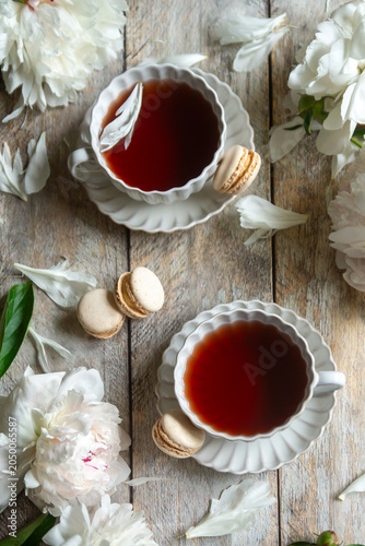 Spring flowers lilac, jasmine, bird cherry, rose hips, roses, peonies, poppies and lilies of the valley, tea and coffee in beautiful porcelain and ceramics.