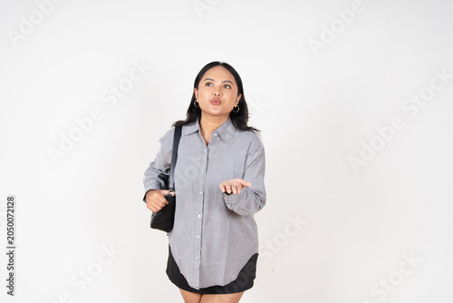 Fotografía Young woman gestures with hands, puckered lips