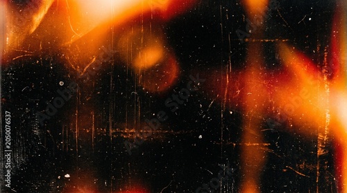 Dramatic film overlay texture with orange and black tones scratches dust and light leaks for cinematic effects and vintage aesthetics