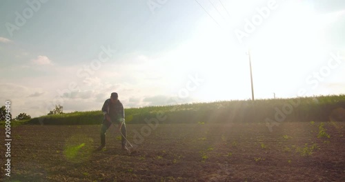 Backlit person standing in a rural field at sunrise