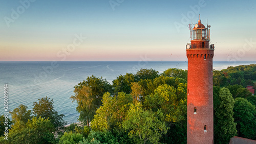 Lighthouse by Baltic sea at sunrise in Poland.