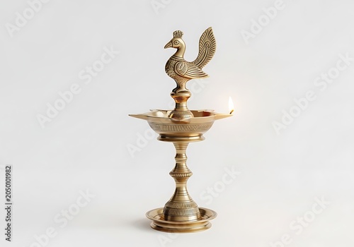 Traditional Indian brass lamp with peacock figurine on top