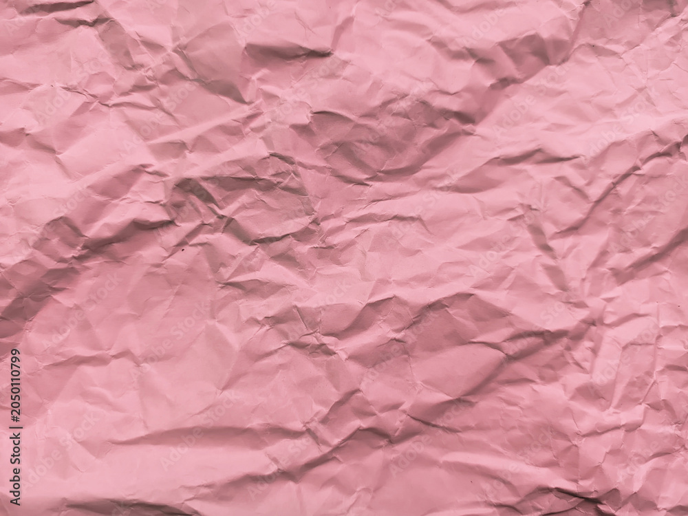 Fototapeta premium detailed close-up texture of a heavily crumpled and wrinkled sheet of pink paper, showing numerous creases, folds, and shaded lines across the surface.