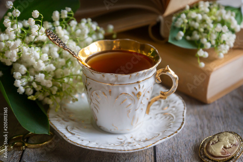 Spring flowers lilac, jasmine, bird cherry, rose hips, roses, peonies, poppies and lilies of the valley, tea and coffee in beautiful porcelain and ceramics.