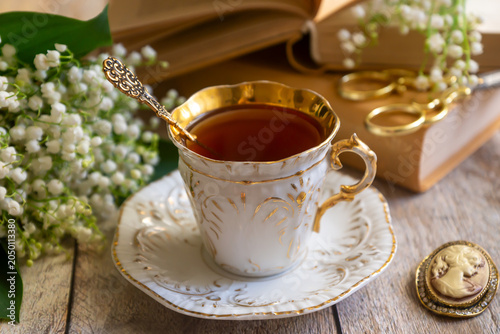 Spring flowers lilac, jasmine, bird cherry, rose hips, roses, peonies, poppies and lilies of the valley, tea and coffee in beautiful porcelain and ceramics.