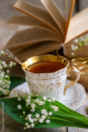 Spring flowers lilac, jasmine, bird cherry, rose hips, roses, peonies, poppies and lilies of the valley, tea and coffee in beautiful porcelain and ceramics.