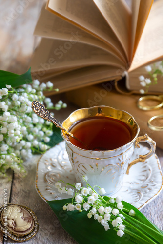 Spring flowers lilac, jasmine, bird cherry, rose hips, roses, peonies, poppies and lilies of the valley, tea and coffee in beautiful porcelain and ceramics.