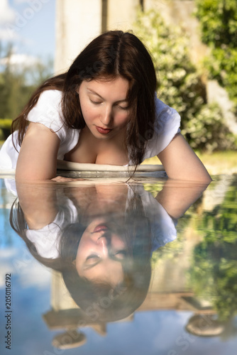 Woman in white dress refreshing