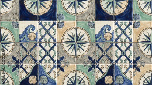 Nautical themed mosaic tiles with compasses waves anchors and shells marine decor.