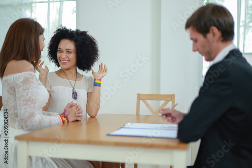 Quadro su tela Married couple sits affectionately expressing their love and goodwill towards each other transgender woman and handsome foreign man sit holding hands gently demonstrating equality