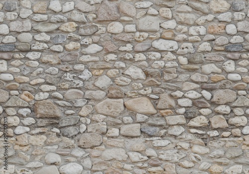 Seamless cobble stone wall texture background. Natural river stone masonry wall backdrop.