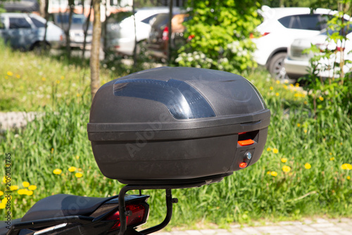 Motorcycle luggage rack. Plastic box for transporting cargo.