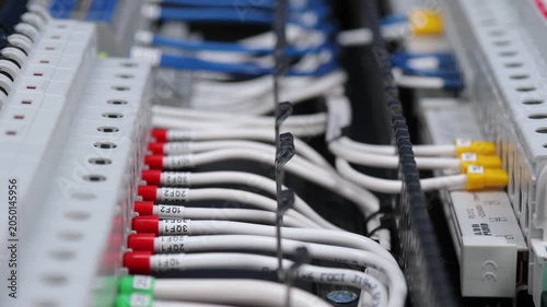 Marking electrical wiring wires with thermally printed nylon tape. 