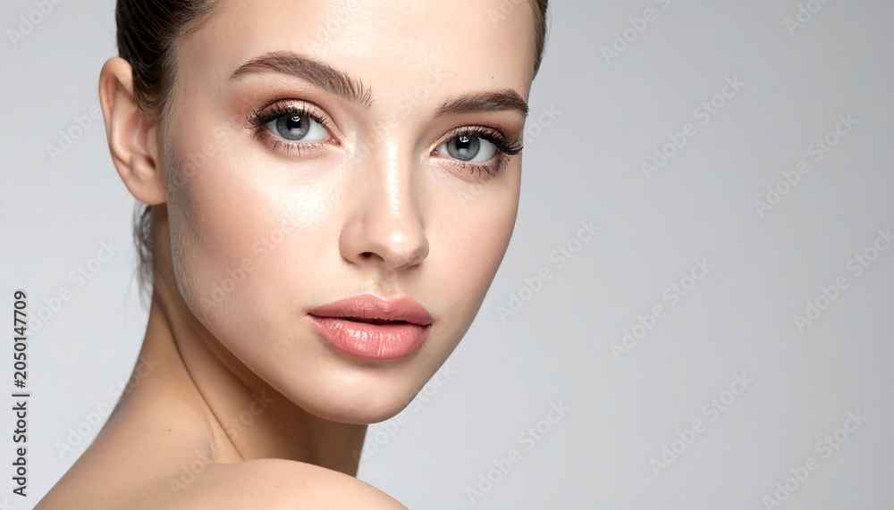 Fototapeta premium A close-up portrait of a young woman with a gentle expression