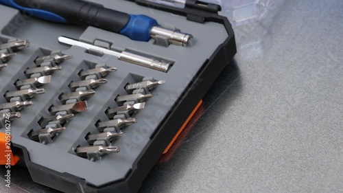 A set of metal bits for installation work in a plastic case.
