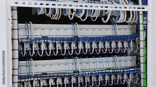 The reverse side of the electrical switchboard. The connected wires are tied with plastic ties.