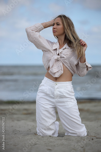 Young Woman Posing on Beach in Striped Shirt