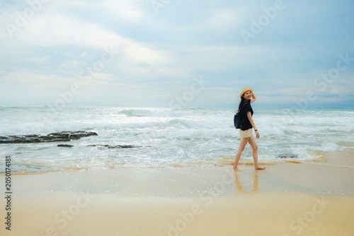 One Asian woman walking on Ao Nui Bay Beach, Ao Nui Bay Ko Lanta Yai, Ko Lanta District, Krabi, Thailand